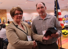 Crystal Abers presenting Farmer of the Year Award to Canticle Farm's farm manager, Mark Printz 