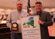 Brian Davis, Cattaraugus County Soil & Water, presenting the Conservation Farm of the Year to Robert Spinler of Triple R Farms